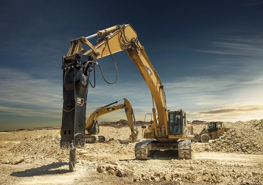 Excavator with hydraulic breaker for underground utility trench installation